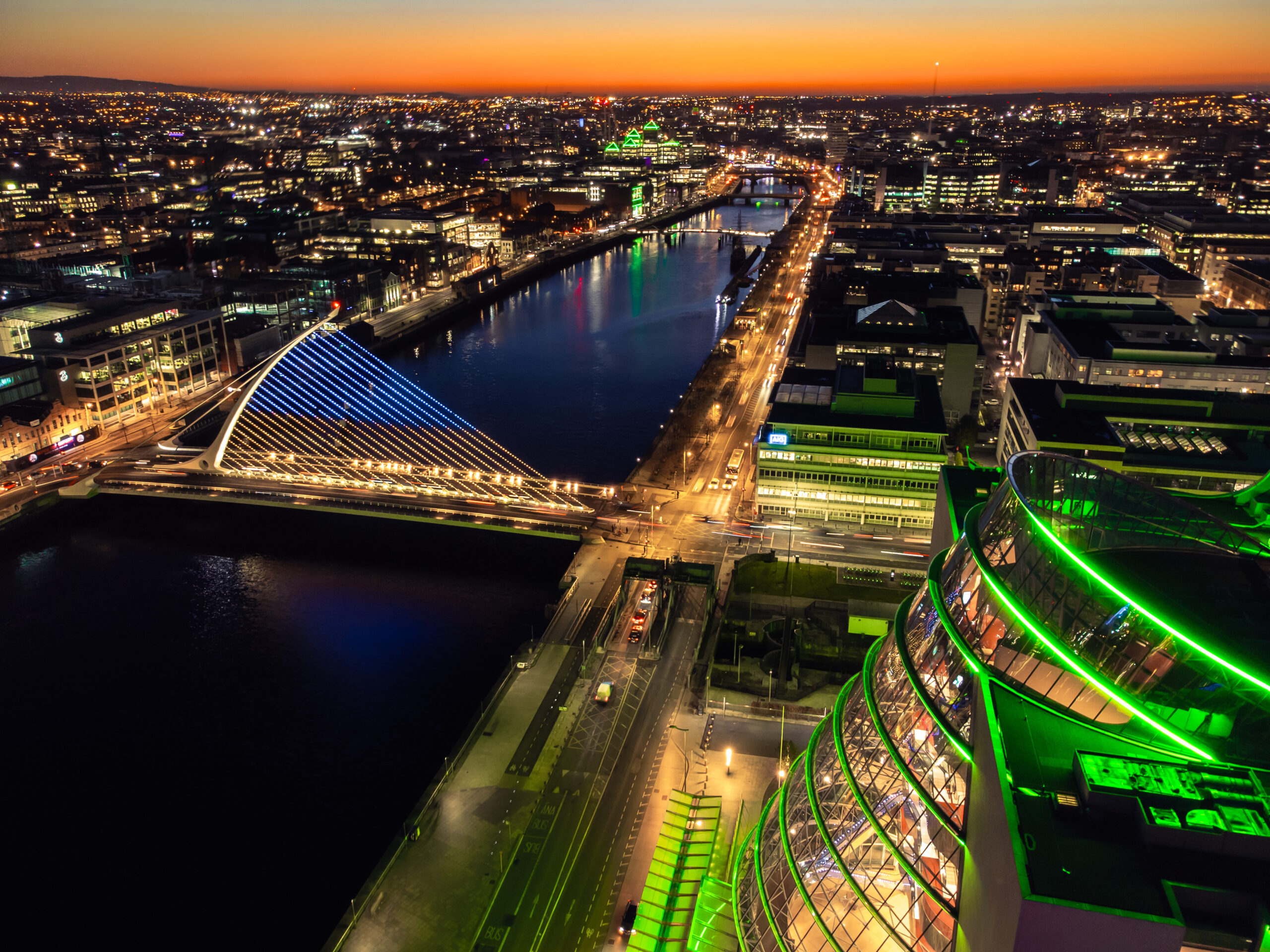 Dublin city at night with lights on and the sunset